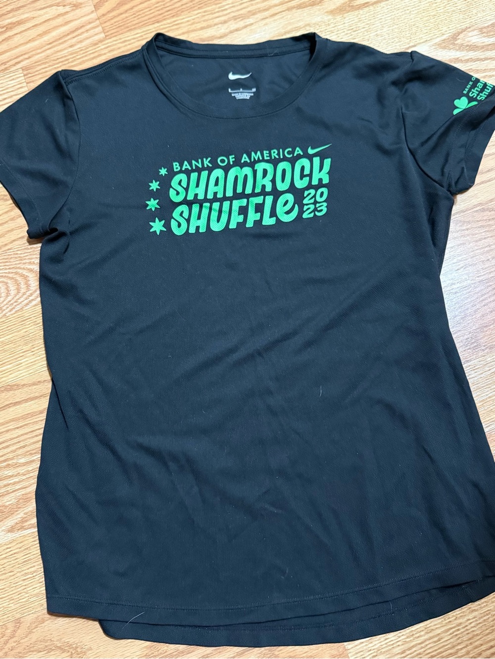 Nike Women’s Black Tee with Green Shamrock Shuffle 2023 Logo